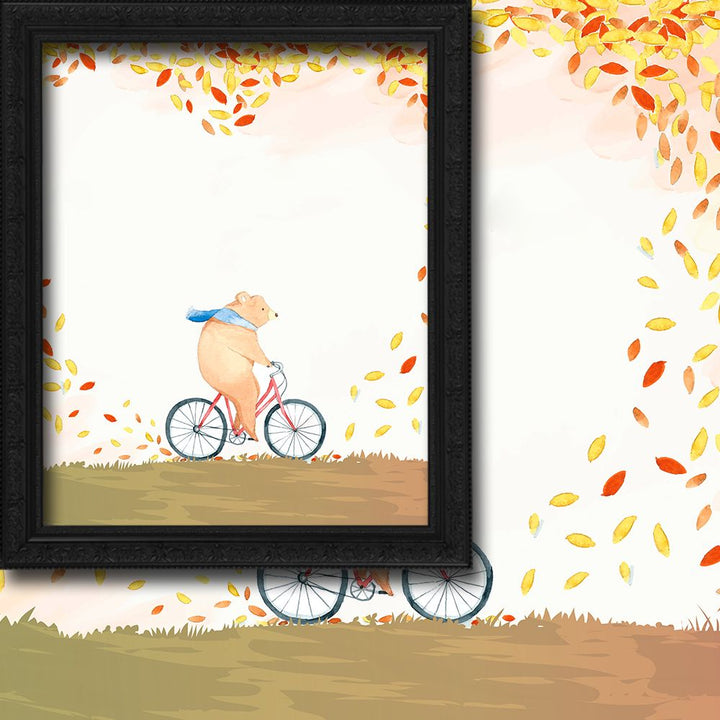 Illustration of a bear riding a bike with autumn leaves falling around, framed artwork.