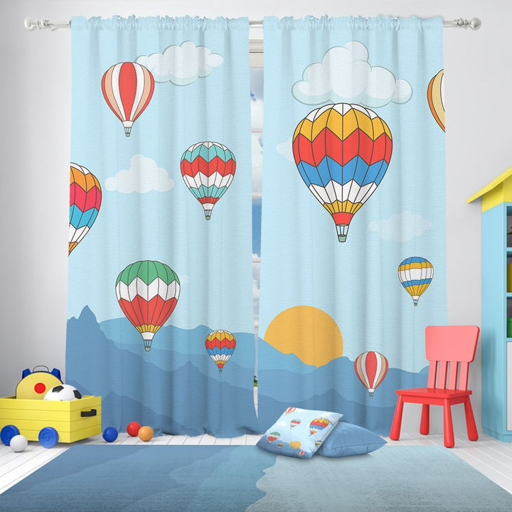 Curtains with colourful air balloon design in a room with toys and a chair.