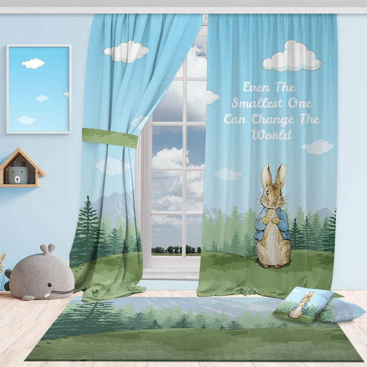 A made to measure kids blackout curtain in soft blue with forest and rabbit motifs, styled with matching rug and cushion for a calm playful room