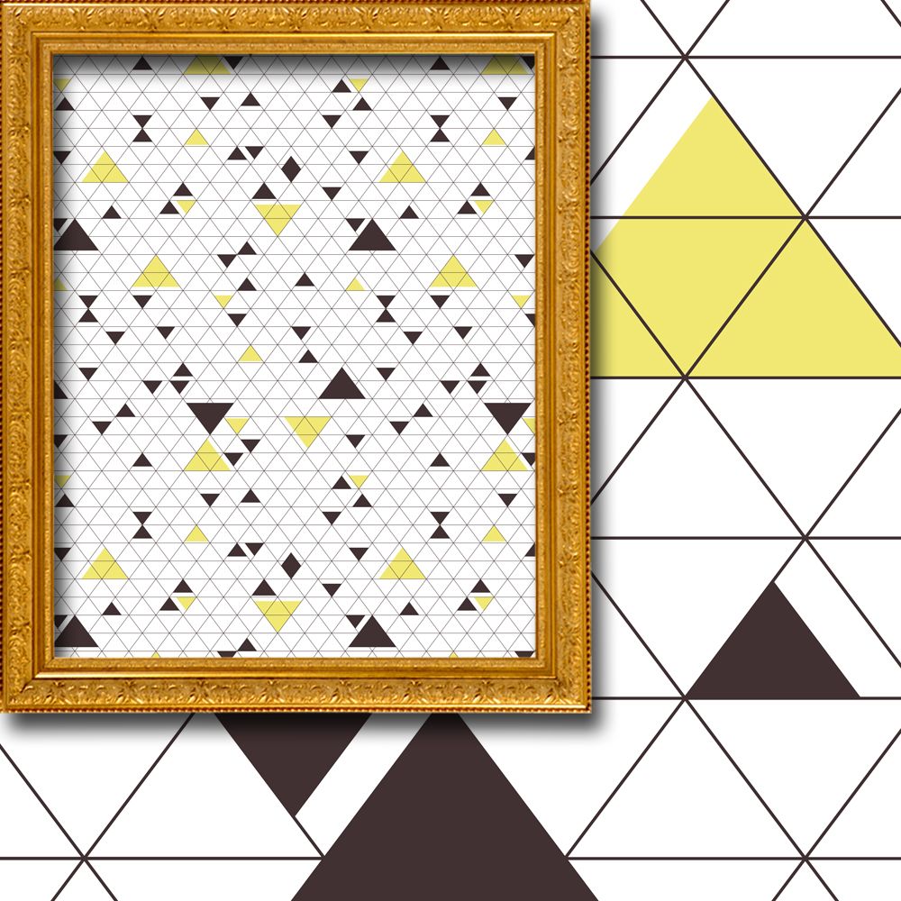Framed geometric pattern with triangles on a white background, placed against a geometric tile wall.