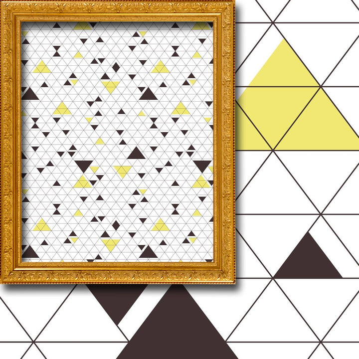 Framed geometric pattern with triangles on a white background, placed against a geometric tile wall.