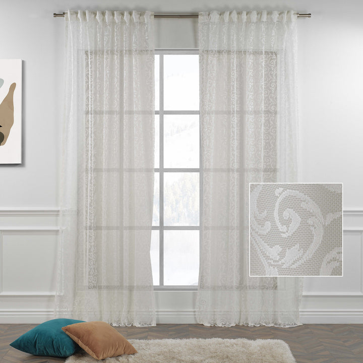 A close‑up of off‑white ivory sheer voile with scalloped embroidered edging, made to measure with premium detailing and soft natural light diffusion