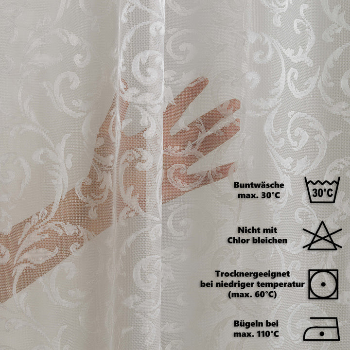 Textile with floral pattern and care instructions on a white background