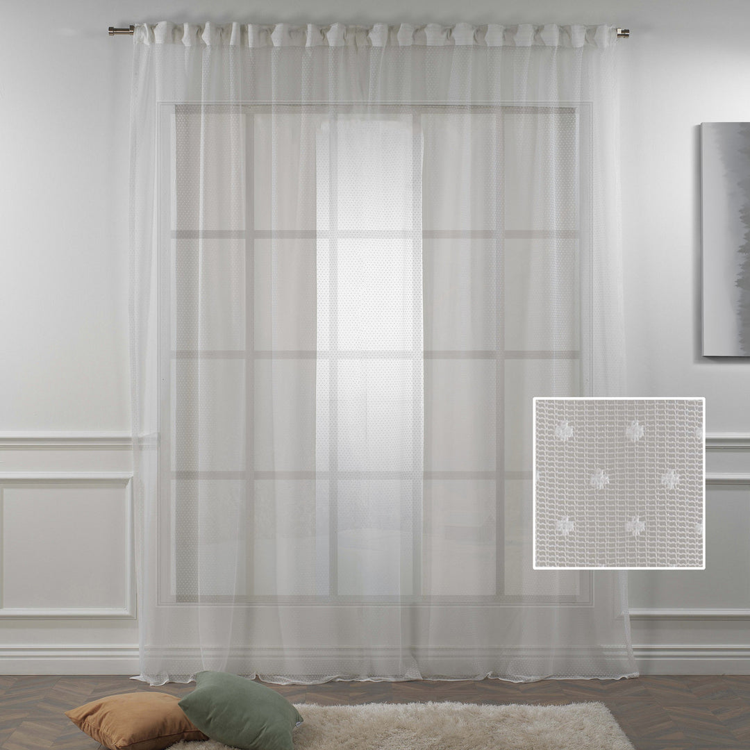 A close‑up of white polka‑dot sheer voile fabric showing its lightweight woven texture, soft translucency and delicate printed dot pattern
