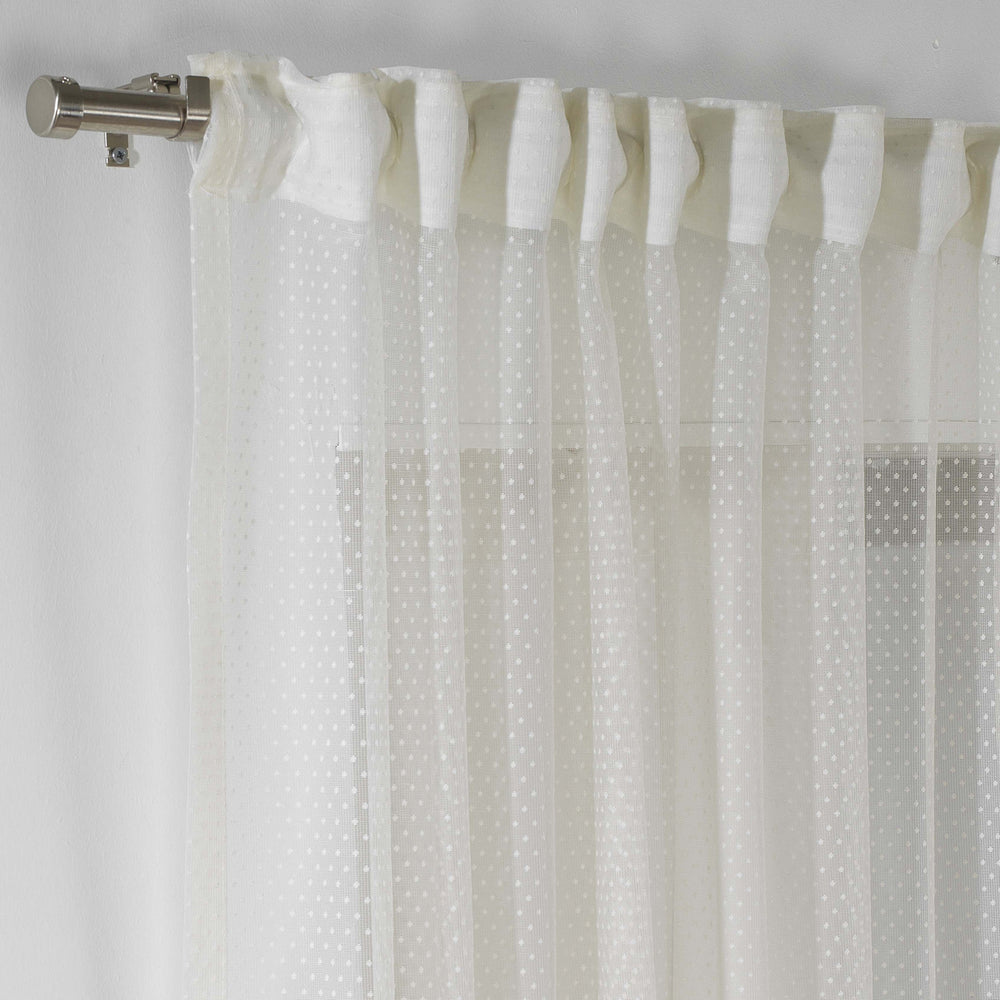 A detailed view of ivory polka‑dot sheer voile fabric showing its airy lightweight weave and evenly spaced printed dot pattern