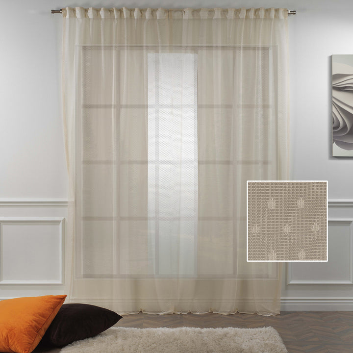 A detailed view of beige polka‑dot sheer voile fabric showing its lightweight airy weave and evenly spaced printed dot pattern