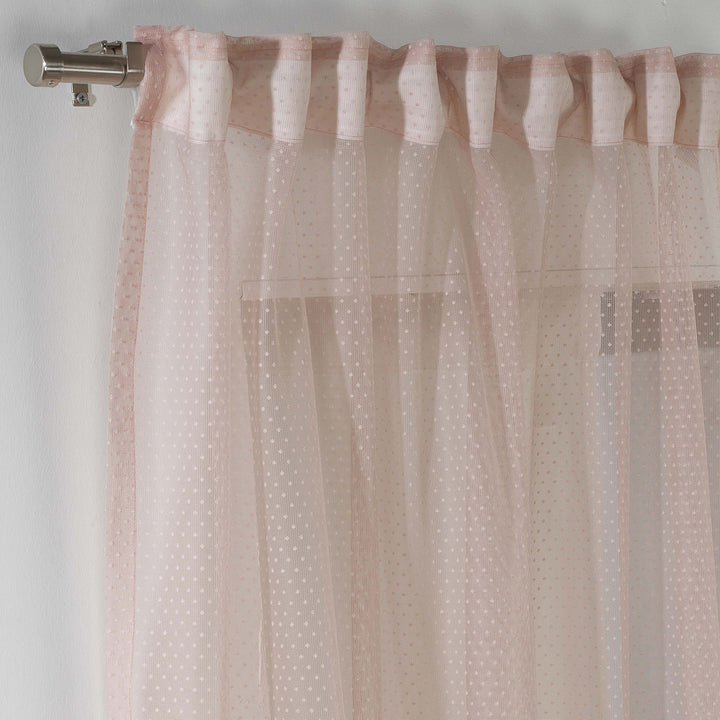 A close‑up of pink polka‑dot sheer voile fabric showing its lightweight woven texture, soft translucency and delicate printed dot pattern