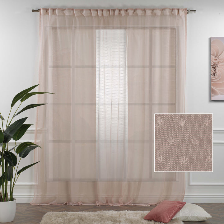 A close detail of pink polka‑dot sheer voile fabric with a lightweight airy texture and soft flowing translucency