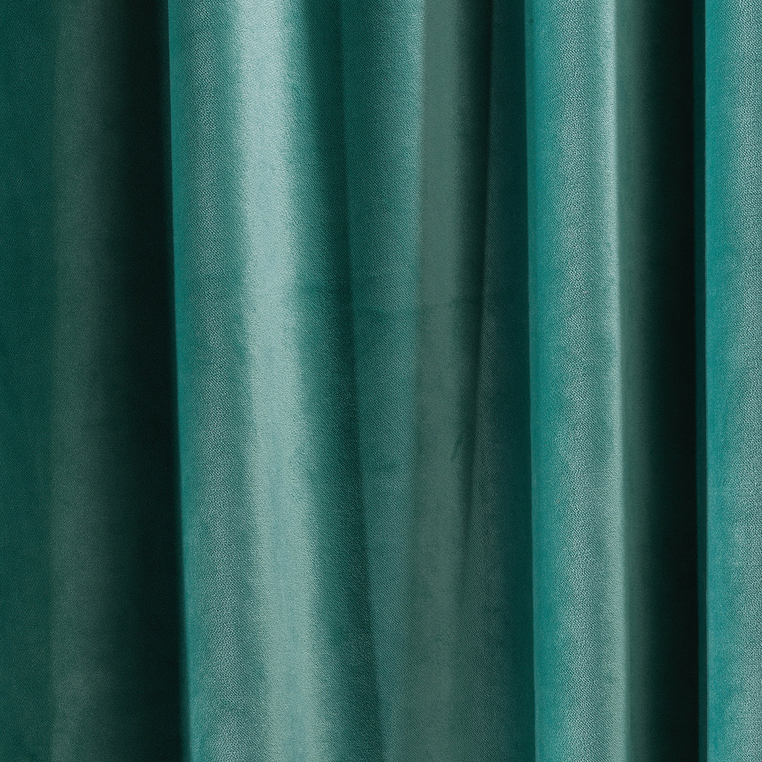 A soft matte velvet swatch in turquoise, showing vibrant blue‑green tone, smooth pile texture and matte surface, made to measure and available by the metre.