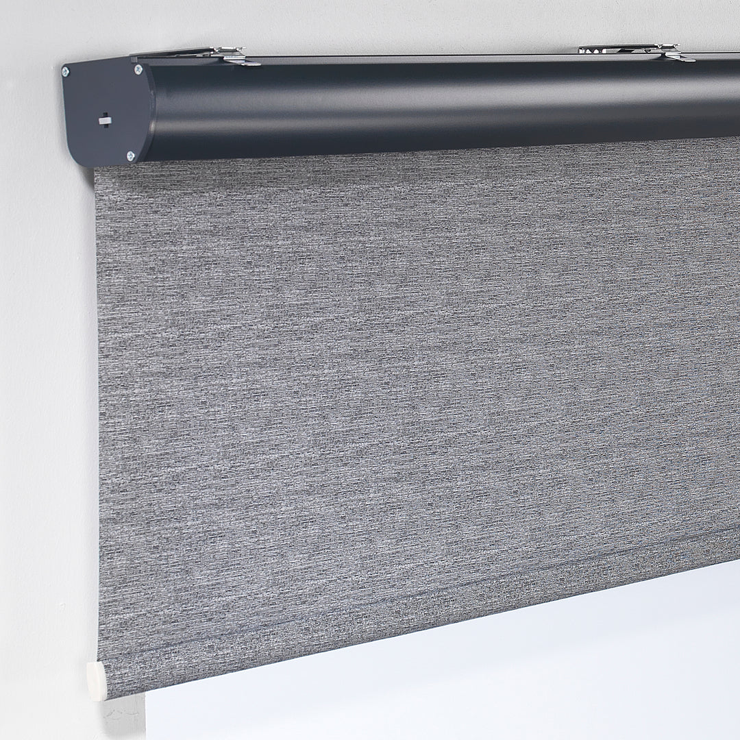 A grey marble‑textured room darkening roller blind made to measure, photographed with a refined stone‑effect finish and balanced dimming