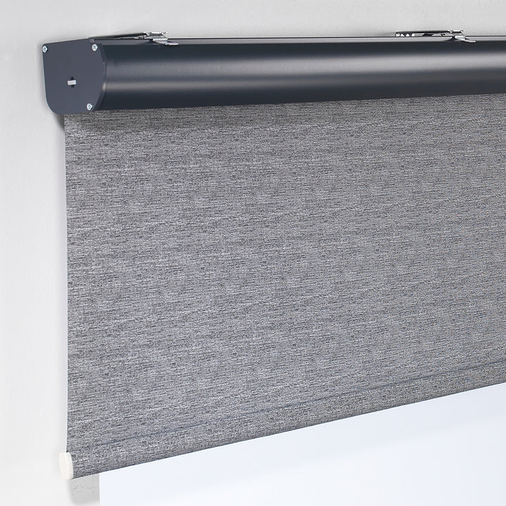 A grey marble‑textured room darkening roller blind made to measure, photographed with a refined stone‑effect finish and balanced dimming