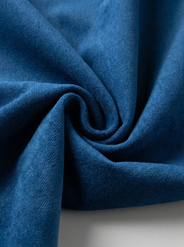 Close-up of blue velvet curtains fabric with a textured surface