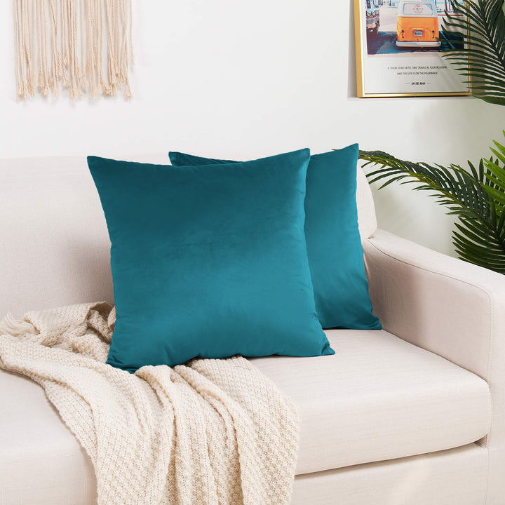 A made to measure cushion cover in muted steel‑blue shiny velvet, shown with a soft reflective sheen and crisp edges for a modern elegant finish