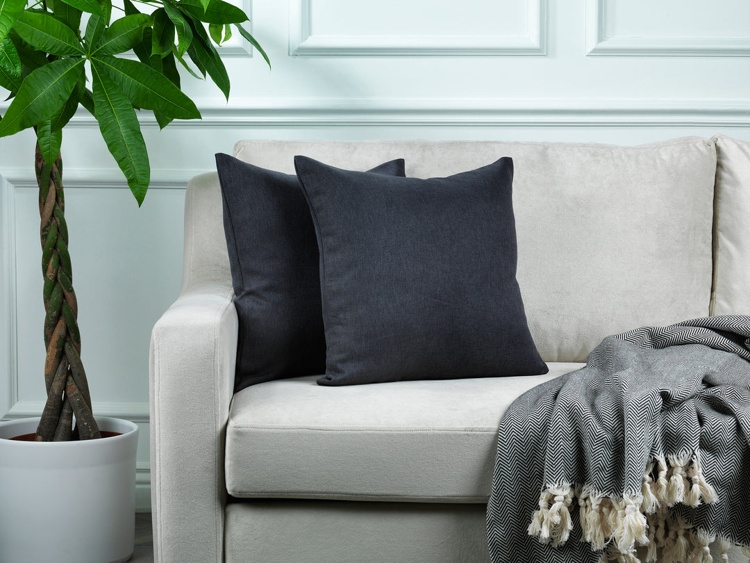 A made to measure cushion cover in dark anthracite linen‑look fabric, shown with a natural textured weave and crisp refined edges for a modern premium style