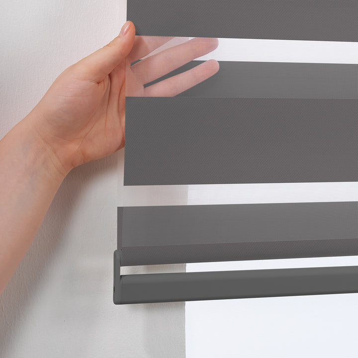 Made to measure anthracite zebra roller blind featuring deep smoky alternating sheer and dim‑out stripes for controlled light and enhanced privacy, highlighting its rich charcoal tone, smooth woven texture and sleek contemporary day‑and‑night blind design