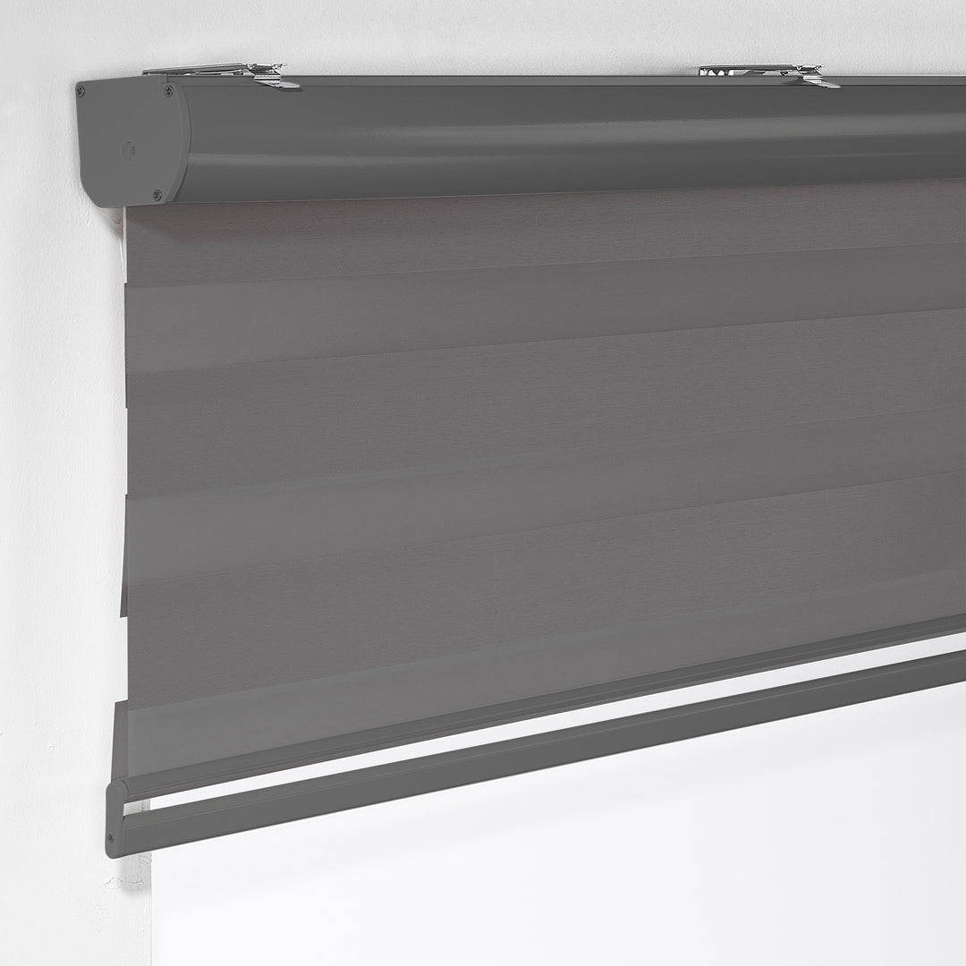 Made to measure anthracite zebra roller blind featuring deep smoky alternating sheer and dim‑out stripes for controlled light and enhanced privacy, highlighting its rich charcoal tone, smooth woven texture and sleek contemporary day‑and‑night blind design