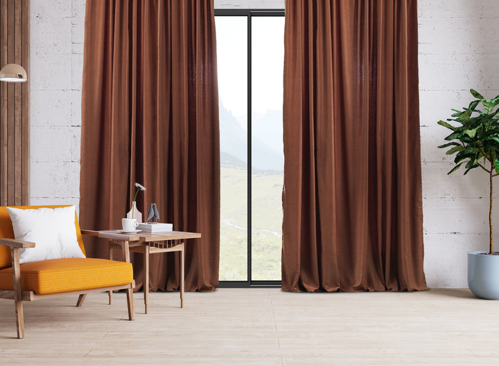 An extra‑long wide linen‑look door curtain in brick, displaying smooth tailored folds and a rich earthy daylight finish