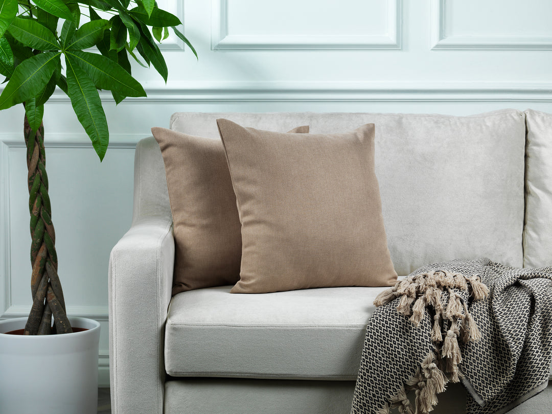 A made to measure cushion cover in warm barley‑beige linen‑look fabric, shown with a natural textured weave and clean tailored edges for a soft neutral look