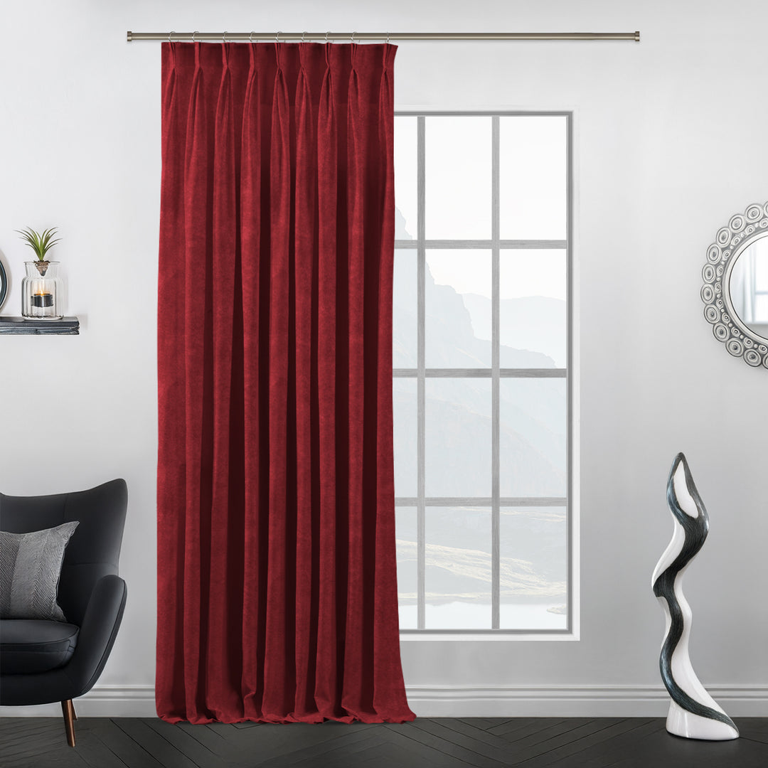 Barn red matte velvet pinch pleat curtain with structured pleats and deep red depth.