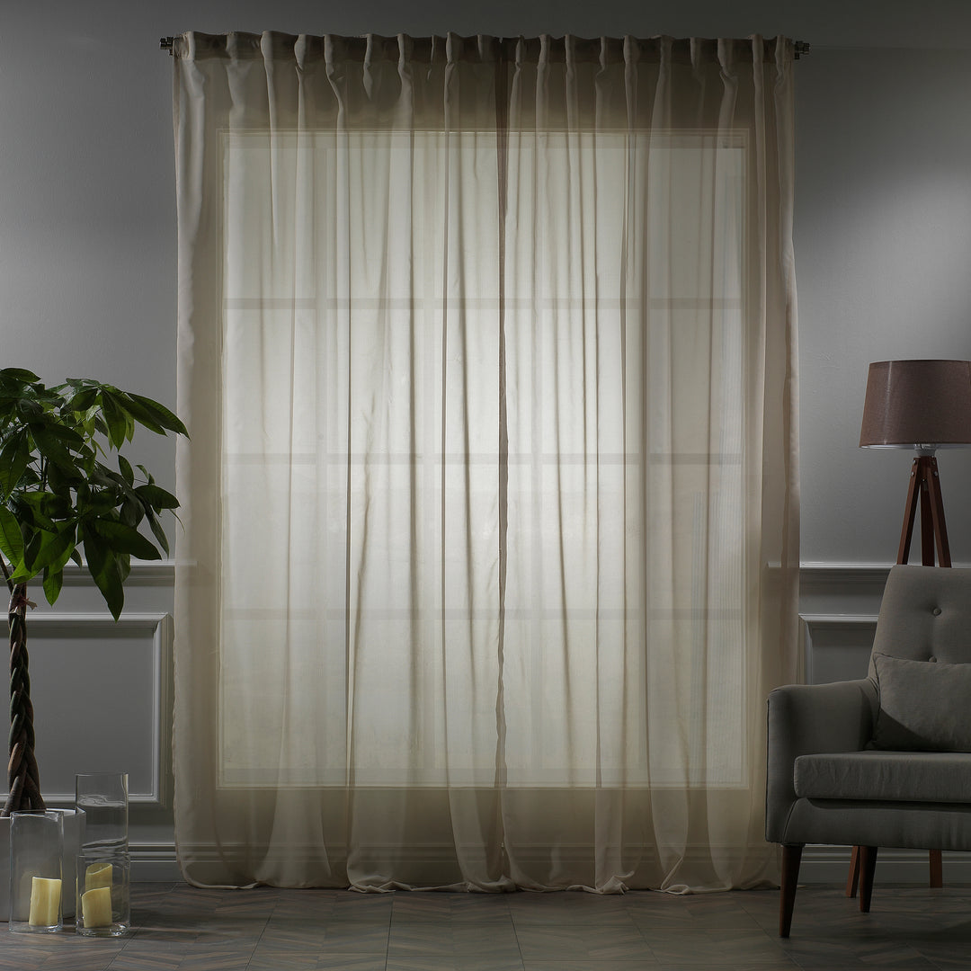 Made‑to‑measure extra‑long and extra‑wide Beige silk‑crepe sheer curtain in evening light, highlighting the fine crepe weave and gentle soft‑glow translucency.