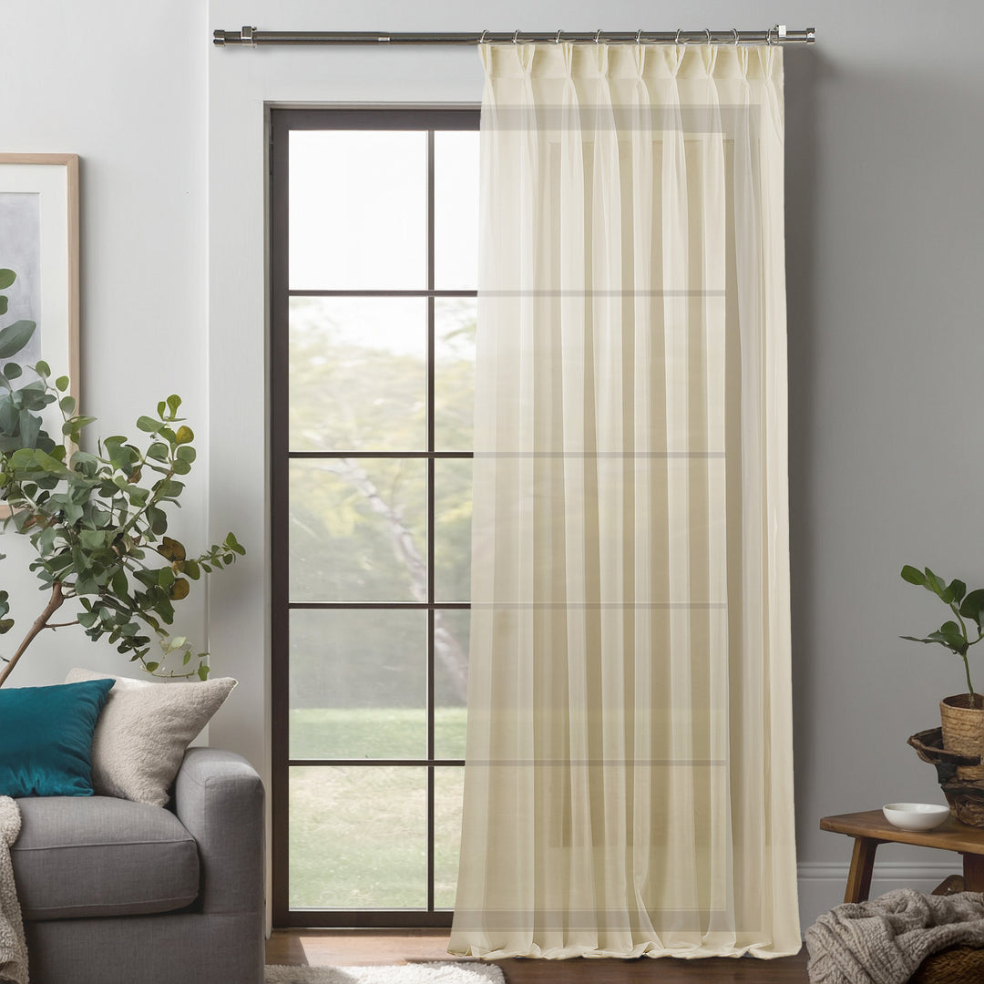 Beige silk‑crepe pinch‑pleated curtain in extra‑long and extra‑wide sizing, blending delicate crepe texture with elegant structured pleats and a smooth flowing drape.