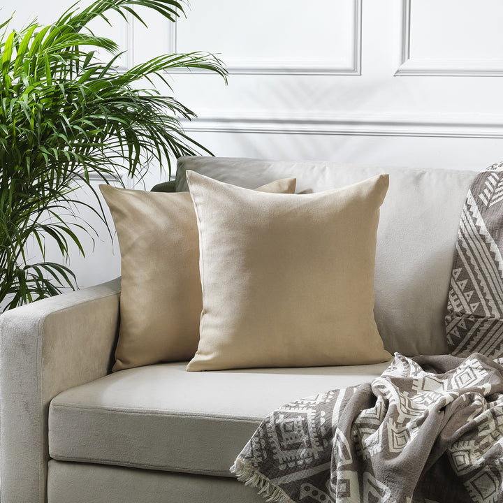 A made to measure cushion cover in warm beige velour, featuring a smooth lightweight surface and clean refined seams for a soft elegant look