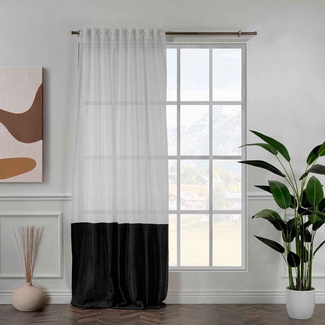 A made to measure black velvet and sheer block curtain, displayed with smooth tailored pleats and a clean modern layered finish