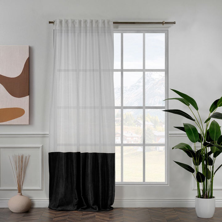 A made to measure black velvet and sheer block curtain, displayed with smooth tailored pleats and a clean modern layered finish