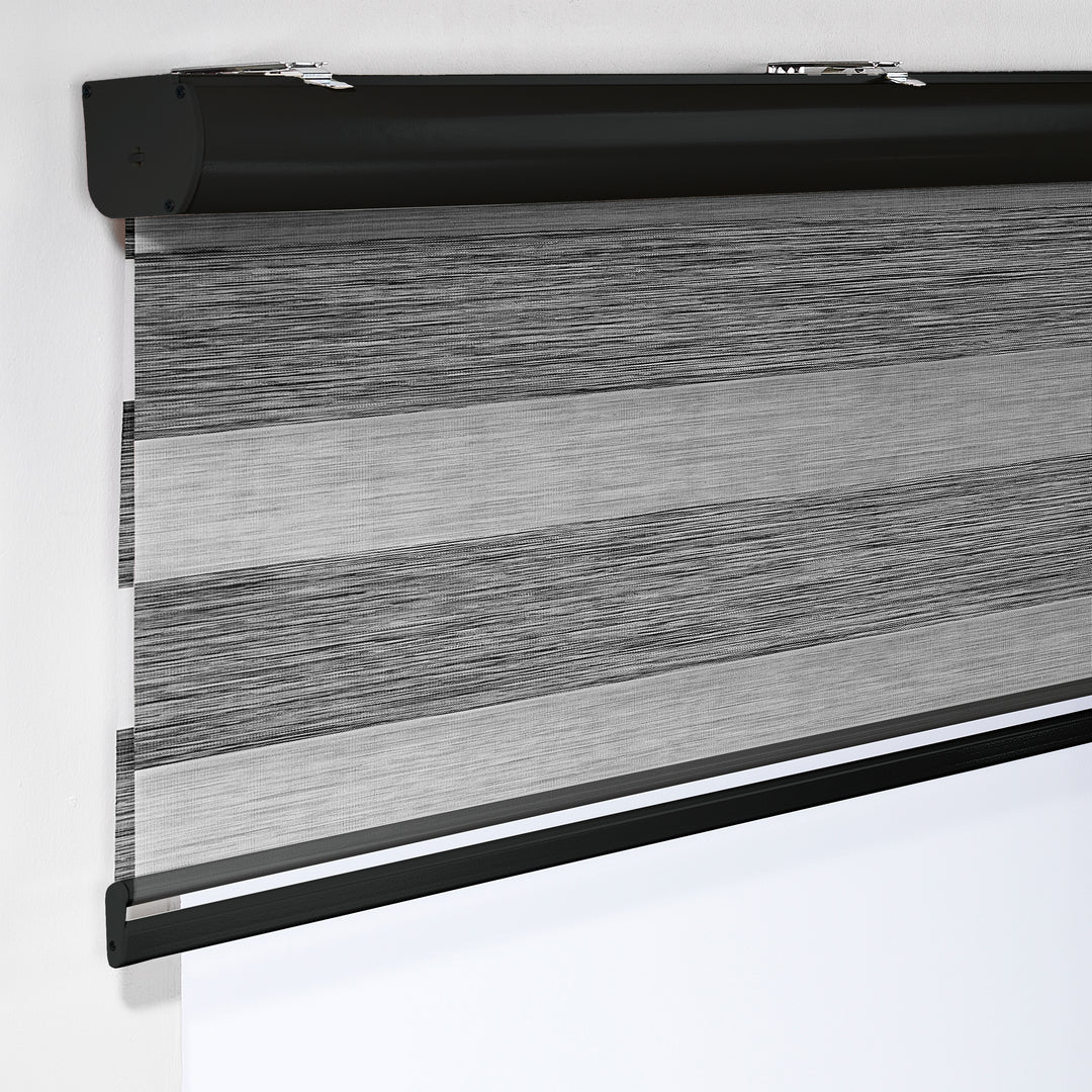 Made to measure zebra roller blind in black, designed with alternating sheer and opaque horizontal stripes for adjustable light control and privacy, highlighting the bold black tone, smooth texture and modern day‑and‑night blind style.