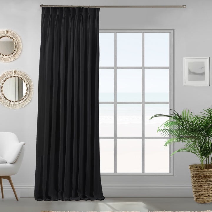 Single black velour curtain panel showing soft drape and premium matte finish.