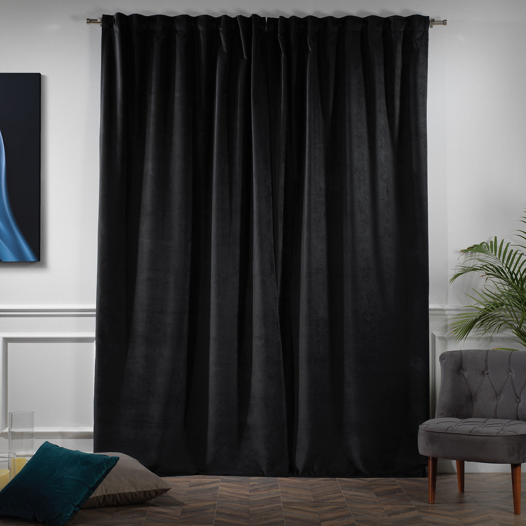 Heavy black matte velvet curtain panel with natural folds and a refined, understated texture.