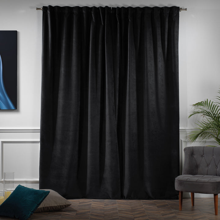 Heavy black matte velvet curtain panel with natural folds and a refined, understated texture.