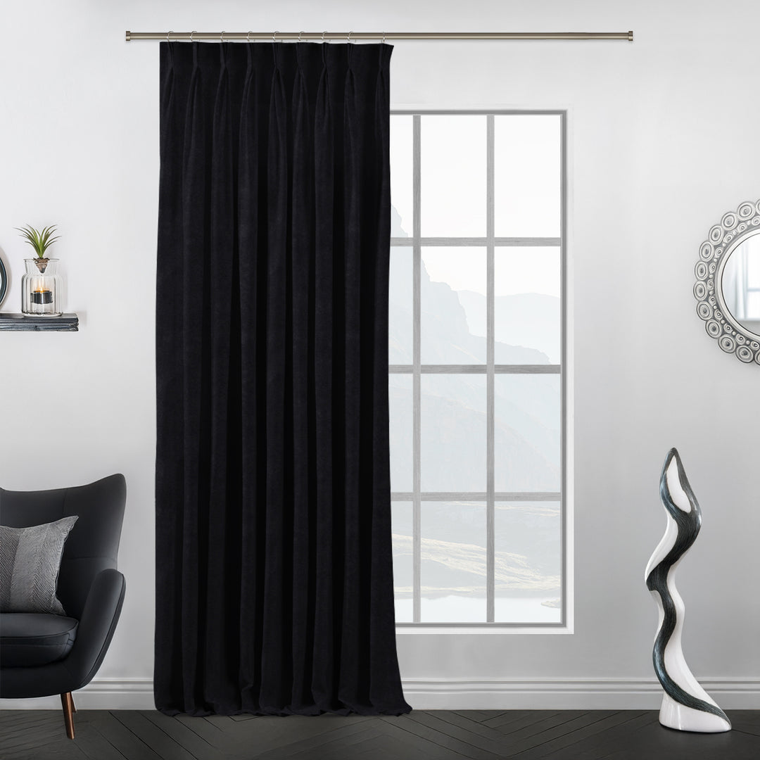 Pinch pleat black matte velvet curtain with sculpted pleats and a long, flowing drop for a tailored finish.