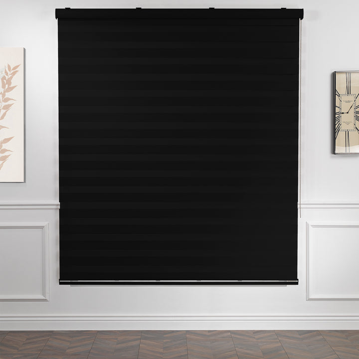 Made to measure solid black zebra roller blind featuring deep alternating sheer and dim‑out stripes that create a strong darkening effect and enhanced privacy, highlighting its bold black tone, smooth woven texture and modern day‑and‑night blind design.