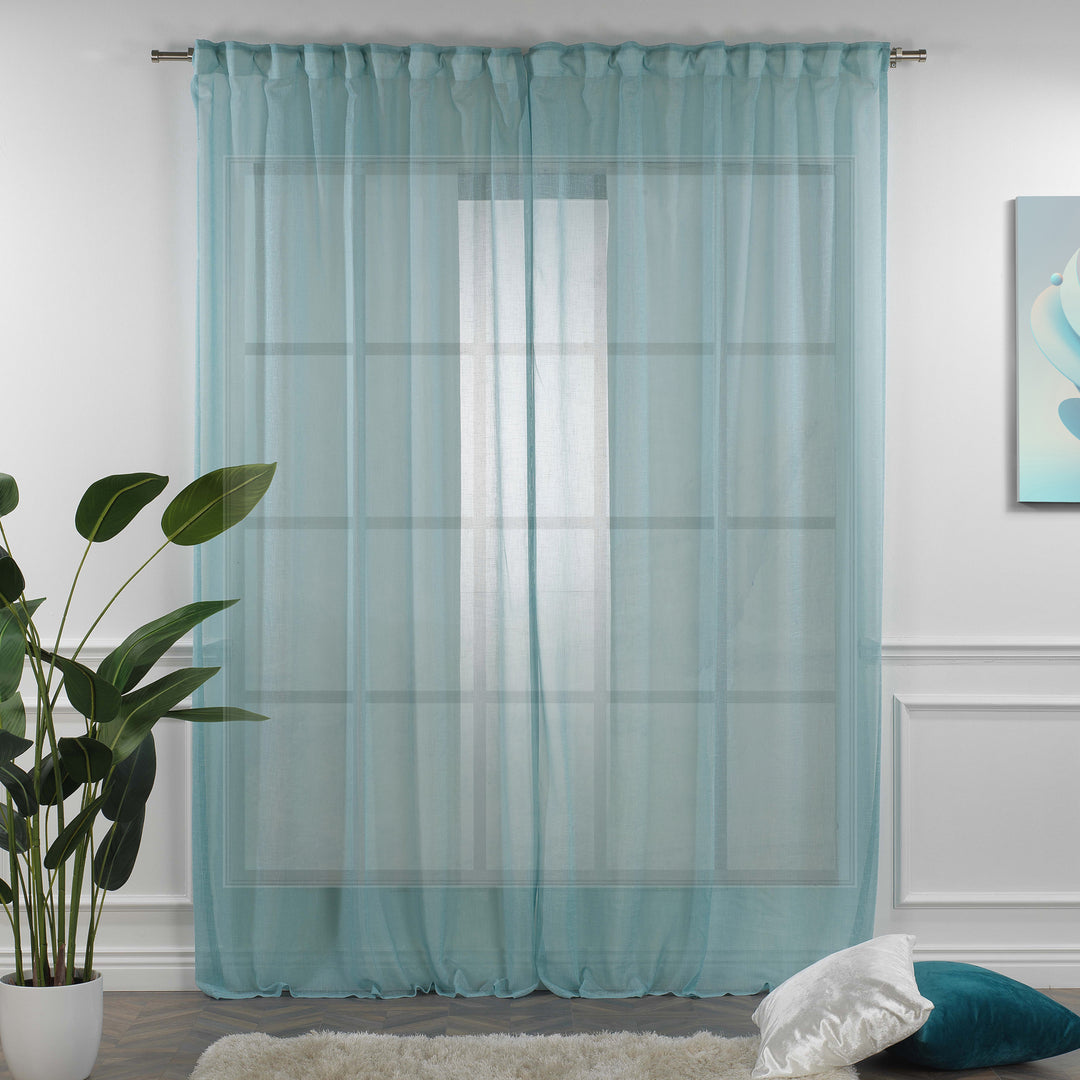 Blue linen sheer curtain fully closed in a modern living room, cool airy texture with soft vertical folds.
