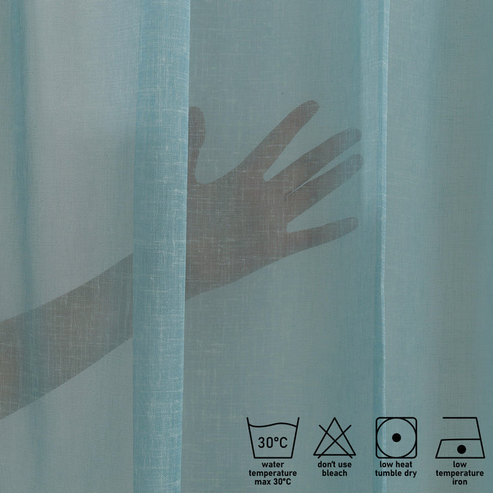 Washing label and fabric detail of blue linen sheer curtain showing weave and care instructions.