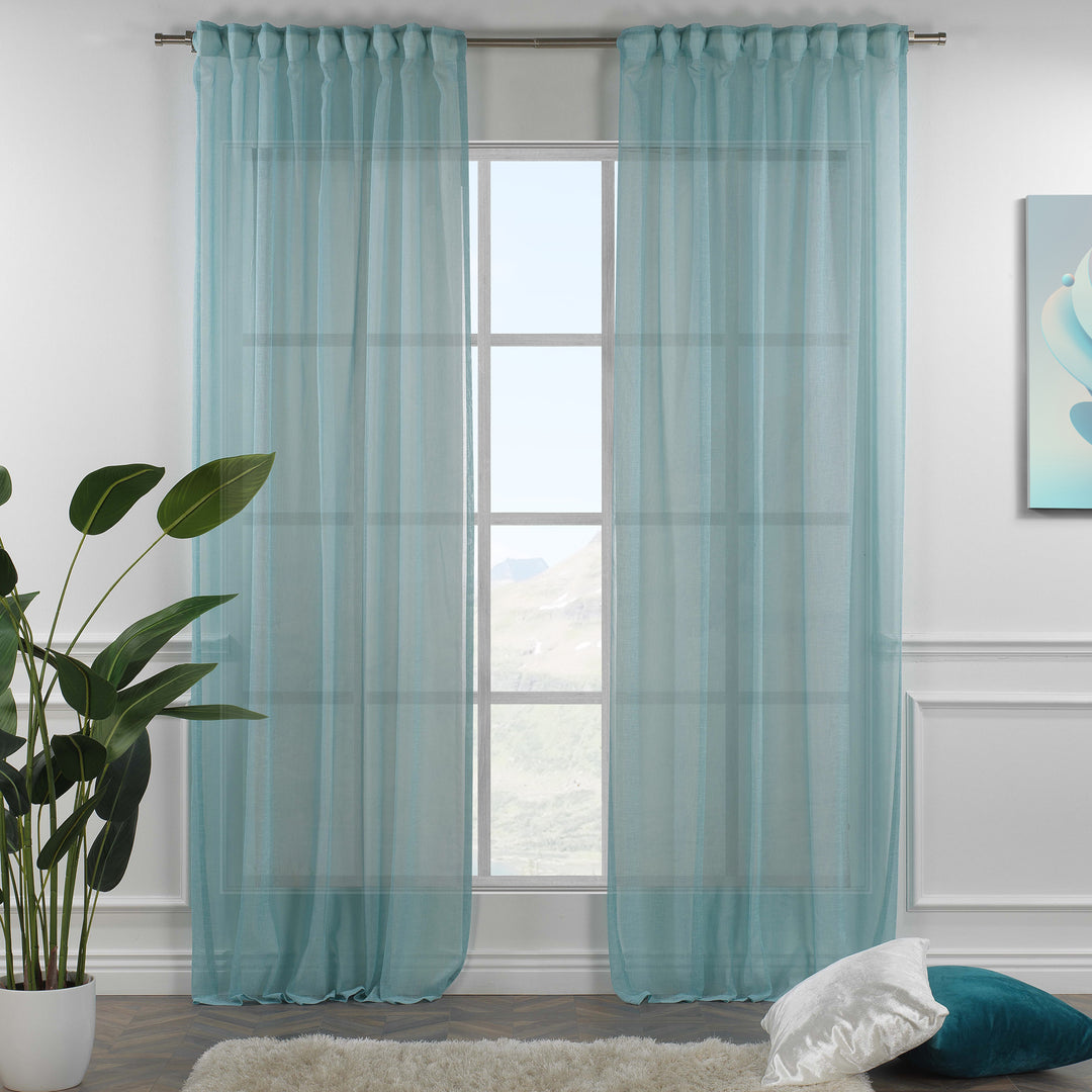 Blue linen sheer curtain with rod‑pocket header in a bright living room, cool tone with airy transparency.