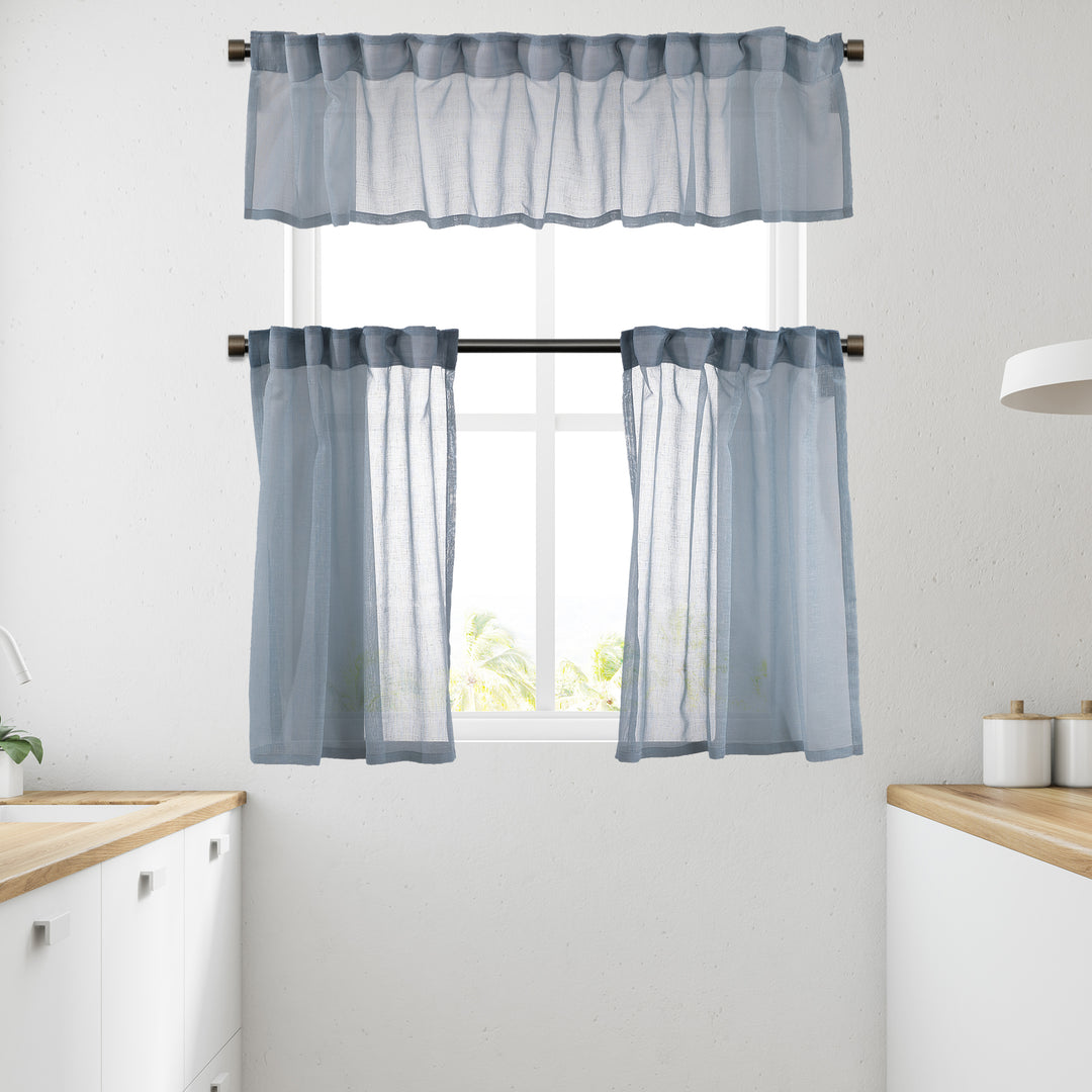 Blue linen‑look sheer valance photographed in daylight, highlighting textured weave and soft translucency.