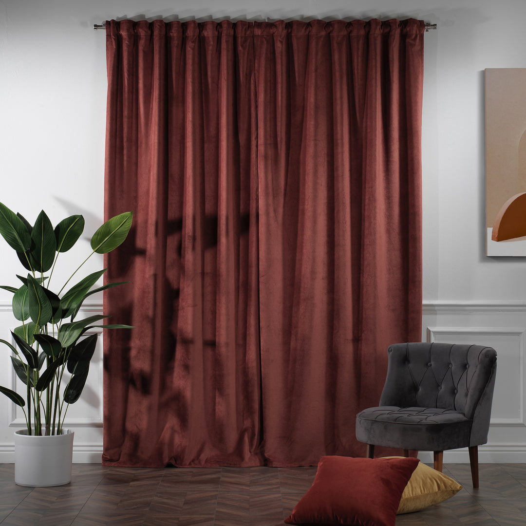 Rust red velvet curtain panel offering wide coverage and warm terracotta depth.