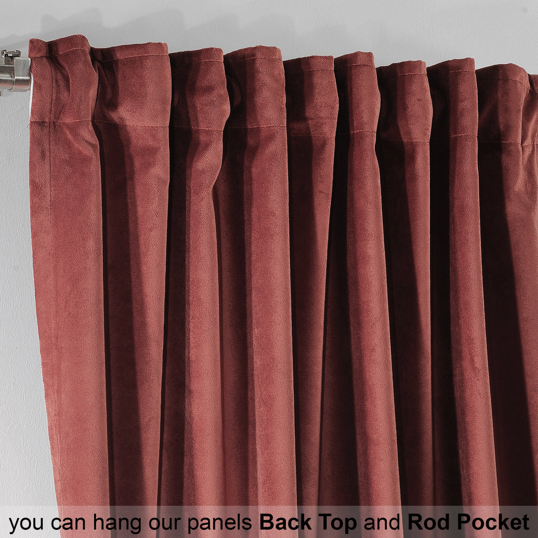 Close‑up of brick red matte velvet curtain fabric showing dense weave and soft‑touch matte texture.