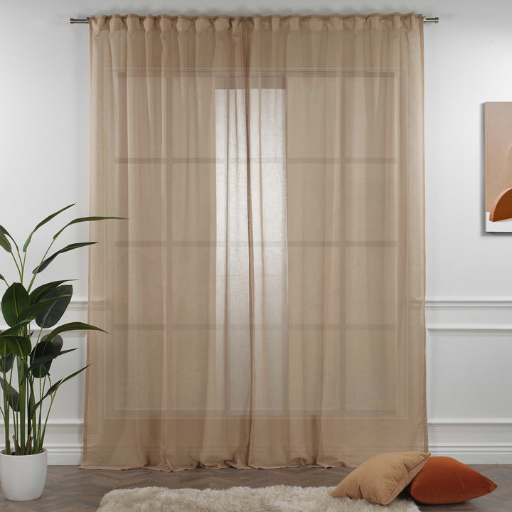 Brown linen sheer curtain fully closed in a warm bedroom, earthy tone with soft folds and natural linen weave.