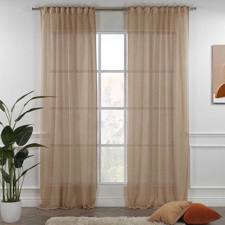 Brown linen sheer curtain with rod‑pocket header in a warm living room, earthy tone with gentle light filtering.