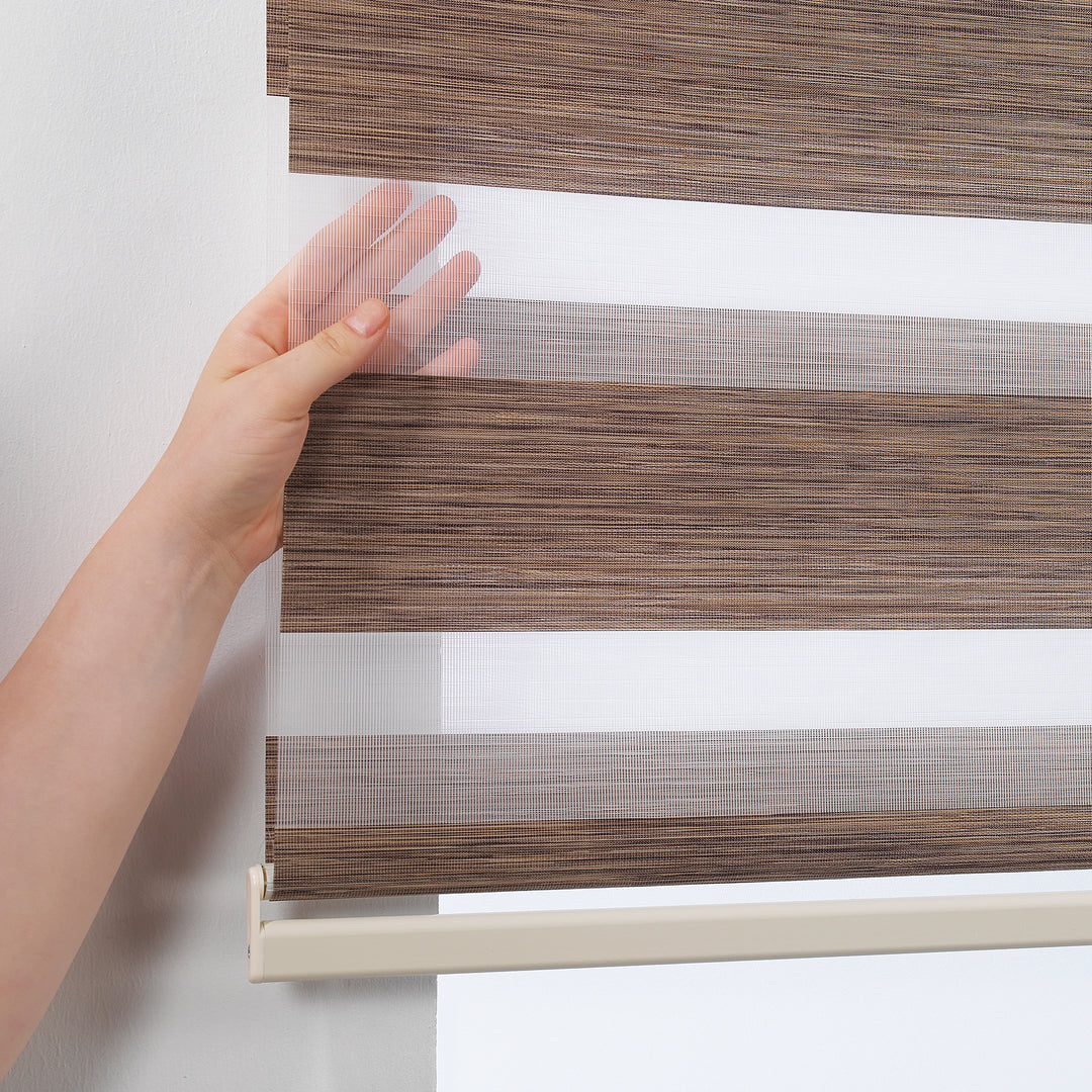 Made to measure zebra roller blind in brown, designed with alternating sheer and opaque horizontal stripes to provide flexible light control and privacy, highlighting the warm brown tone, refined texture and modern day‑and‑night blind style.