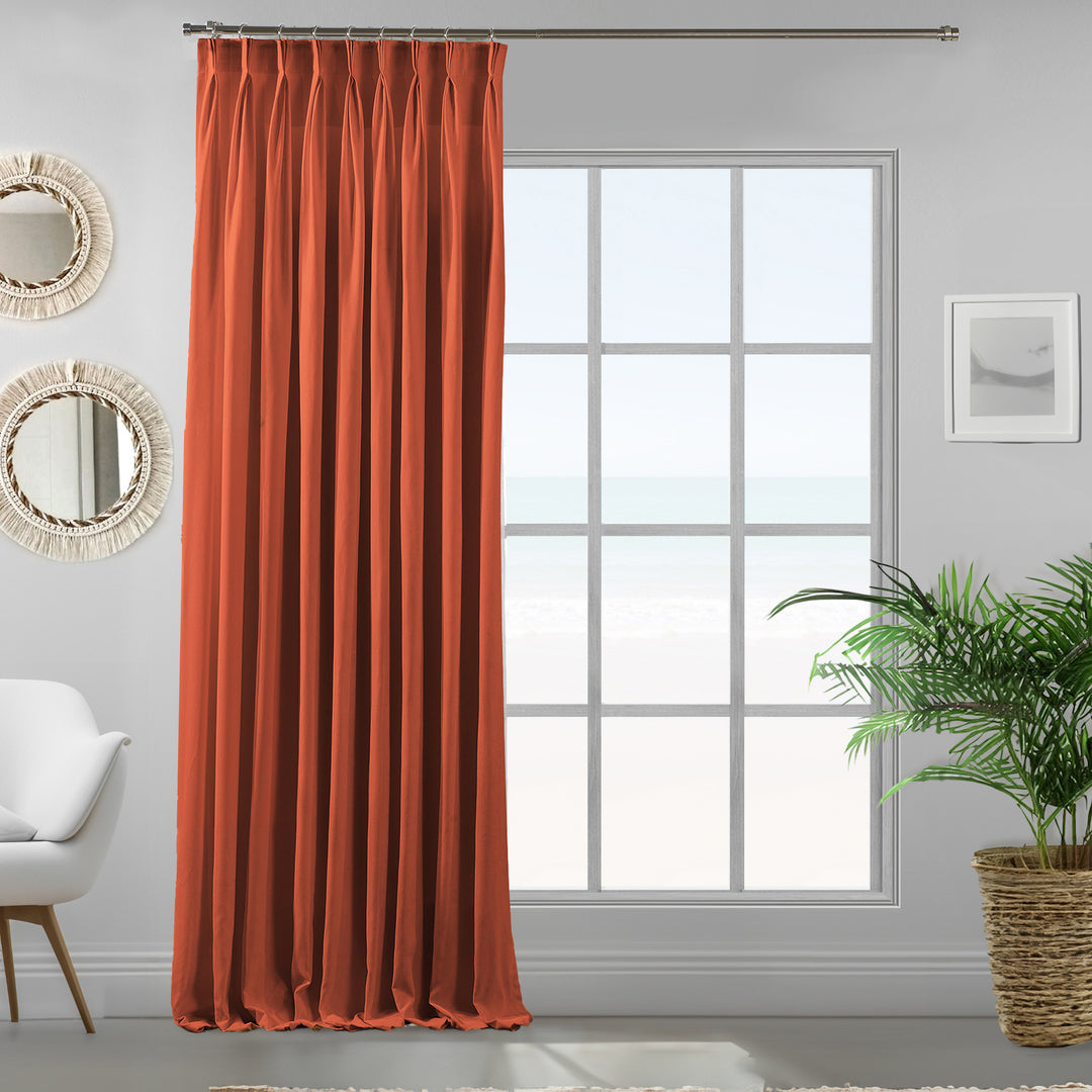 Made to measure pinch pleated burnt orange velour curtain panel showing soft drape and refined matte finish.