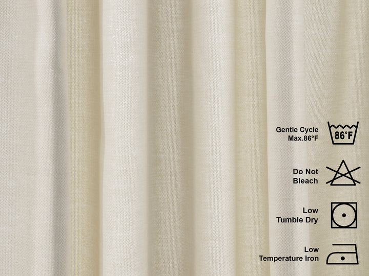 Textile with washing and care instructions on a beige linen look curtains fabric background