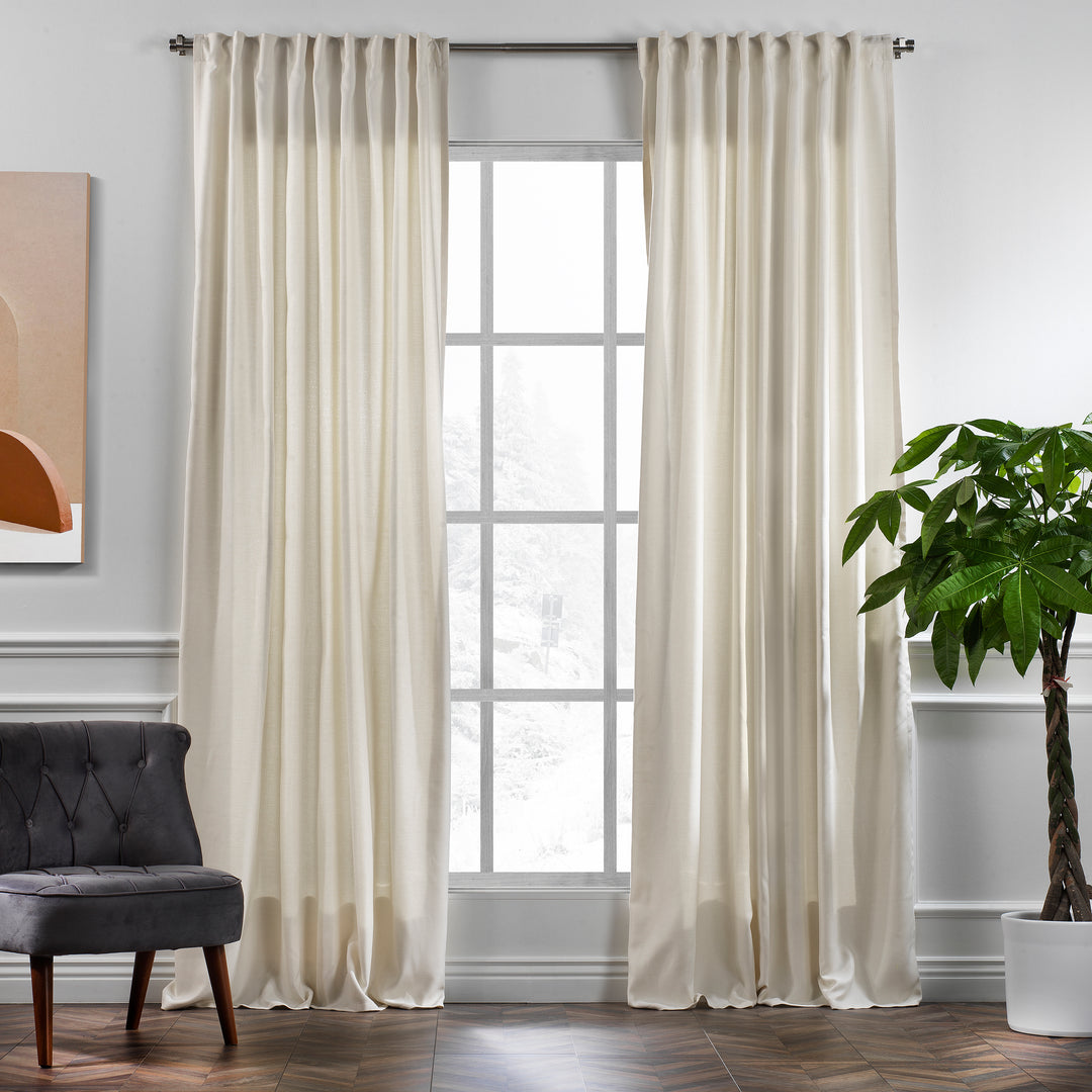 A made to measure linen‑look curtain in cream, photographed in daylight with soft woven texture and a clean elegant drape