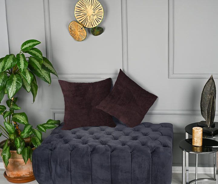A made to measure cushion cover in muted wine‑red matte velvet, featuring a velvety surface and clean refined seams for a warm sophisticated look