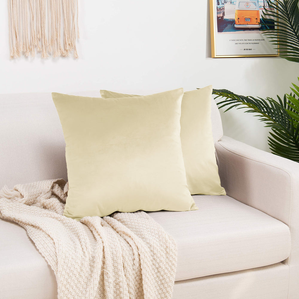 A made to measure cushion cover in soft cream shiny velvet, displaying a gentle glossy texture and crisp seams for a bright elegant appearance