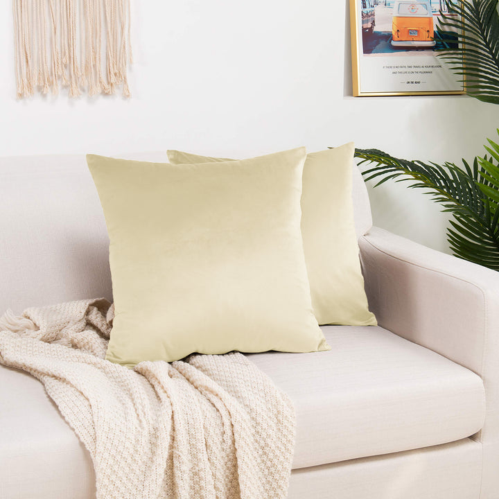 A made to measure cushion cover in soft cream shiny velvet, displaying a gentle glossy texture and crisp seams for a bright elegant appearance