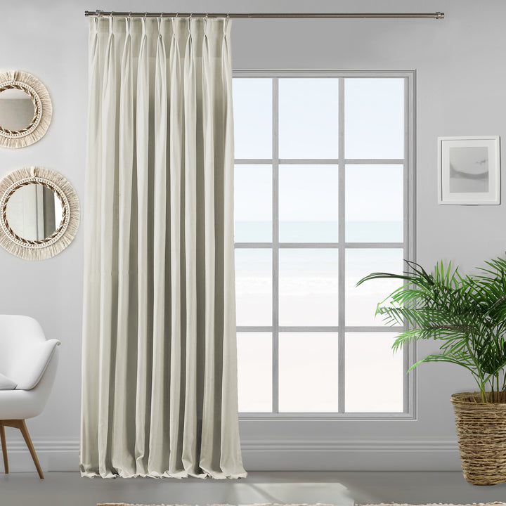 Pinch pleated cream velour curtain panel showing soft drape, matte finish and refined tailored fall.